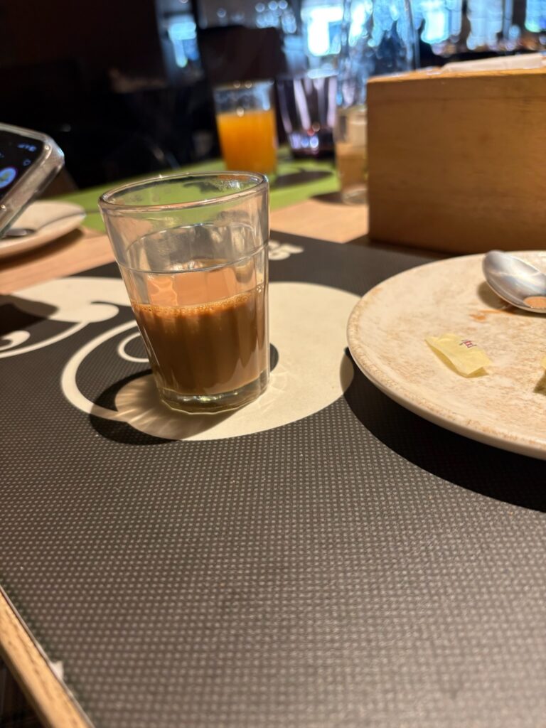 Traditional cutting chai glass served at Hilton Garden Inn breakfast buffet.