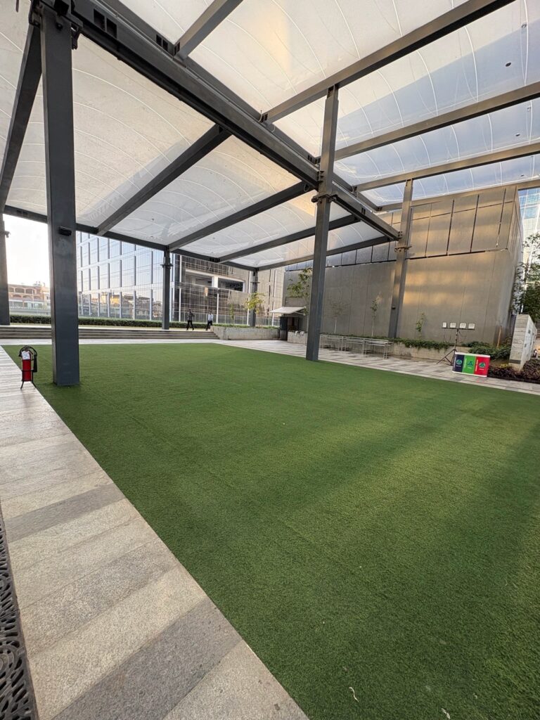 Covered outdoor event lawn and green space at Hilton Garden Inn Manyata campus.